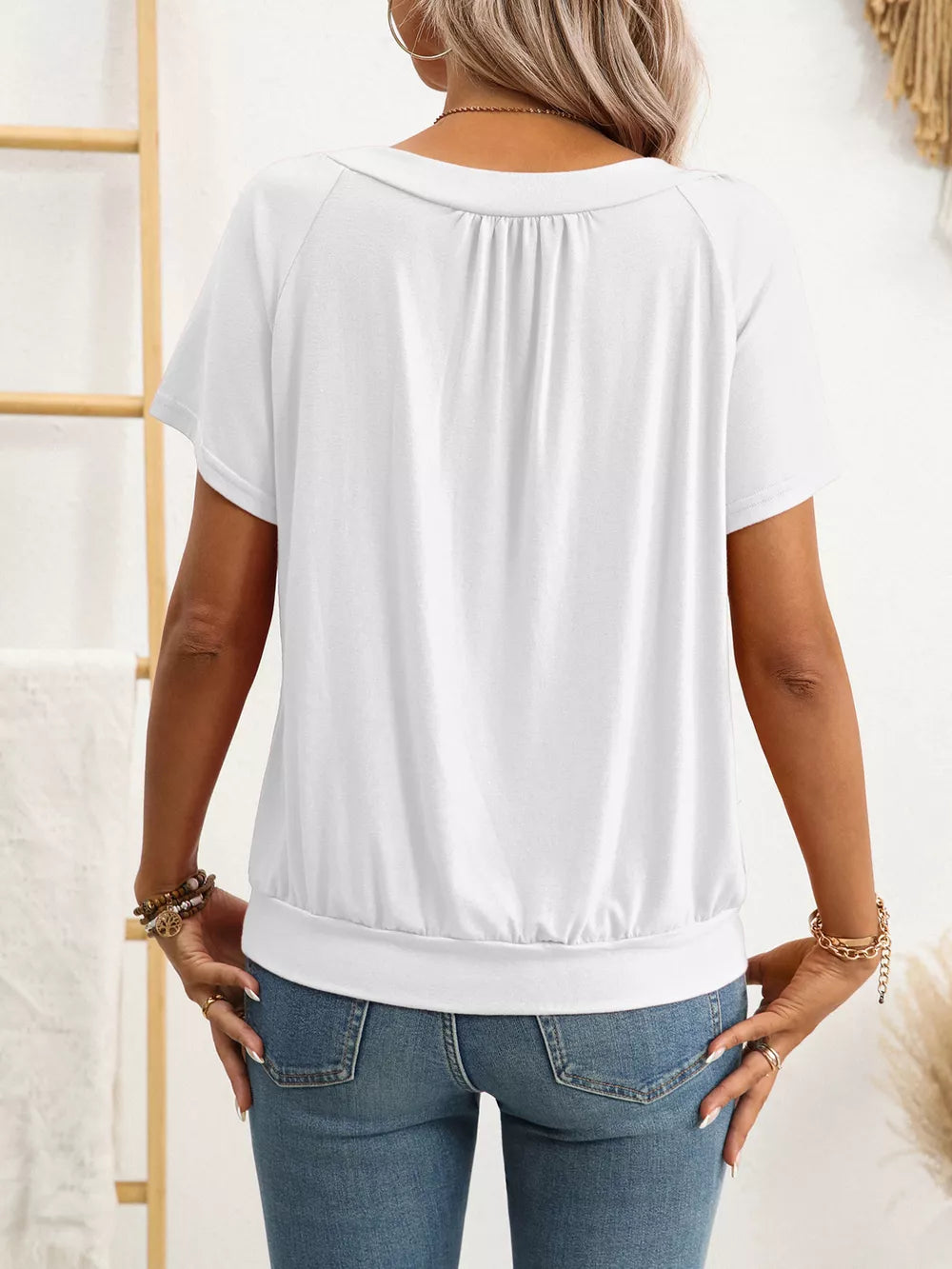 White ruched V-neck t-shirt with short sleeves and banded hem.