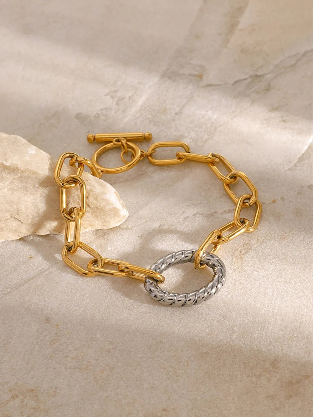 Gold chain bracelet with toggle clasp and two-tone oval link detail