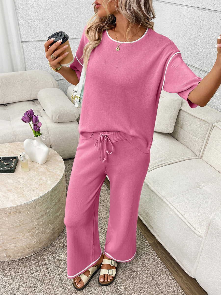 Fuchsia pink loungewear set with crew neck top and drawstring pants, white piping detail