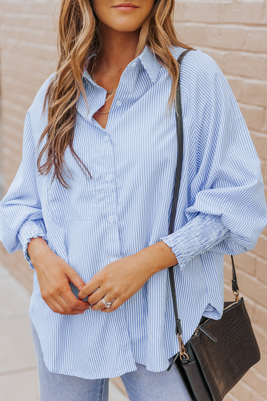 Pastel blue pinstripe blouse with balloon sleeves and smocked cuffs.