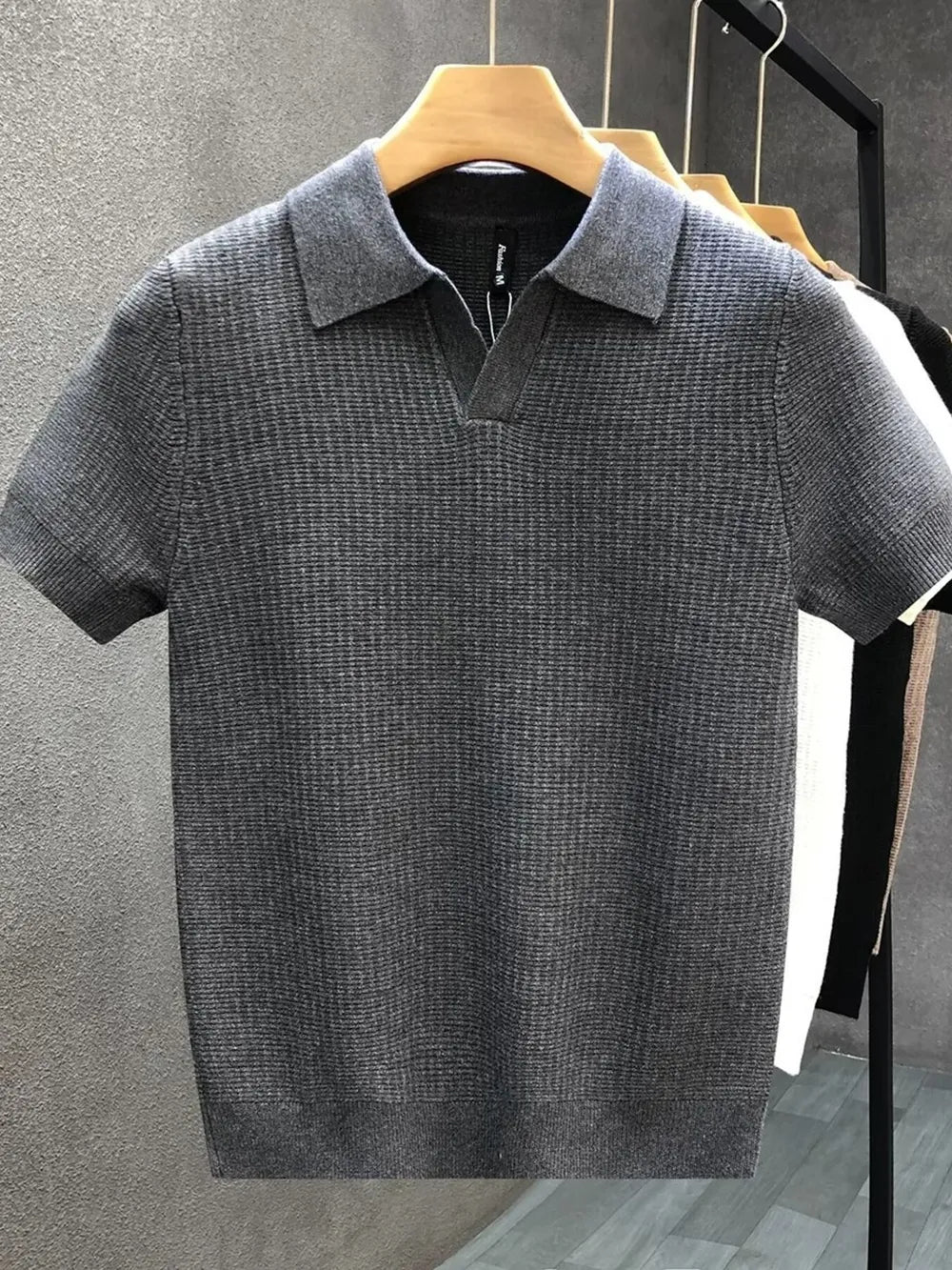 Grey textured knit short sleeve polo shirt with a V-neck collar.
