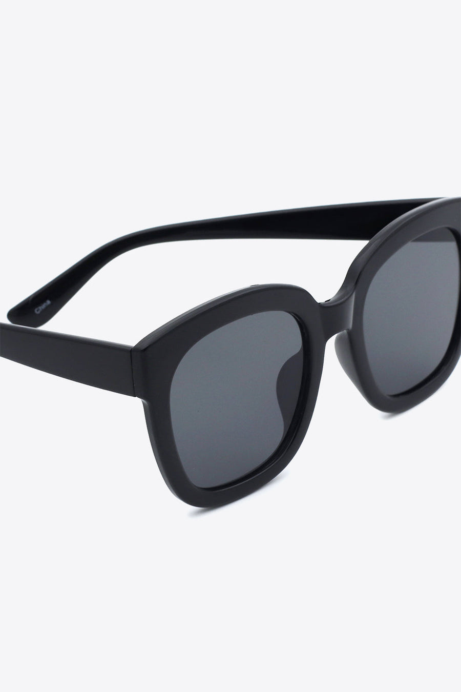 Black square sunglasses with dark lenses and thick frames.