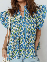 Floral ruffle sleeve tie-neck blouse with blue floral print and frill trim.