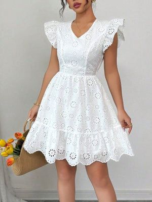 White eyelet mini dress with ruffle sleeves and v-neck, tiered hem.