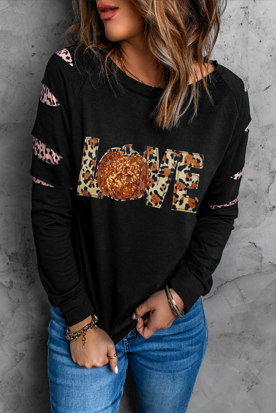 Black sweatshirt with leopard print LOVE graphic and cutout sleeves.