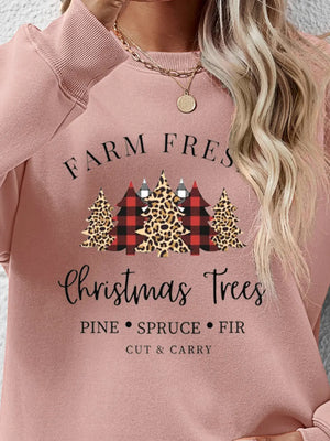 Blush pink crewneck sweatshirt with Christmas trees graphic and text.