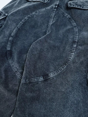 Textured blue corduroy cargo pants with functional pockets and seam details.