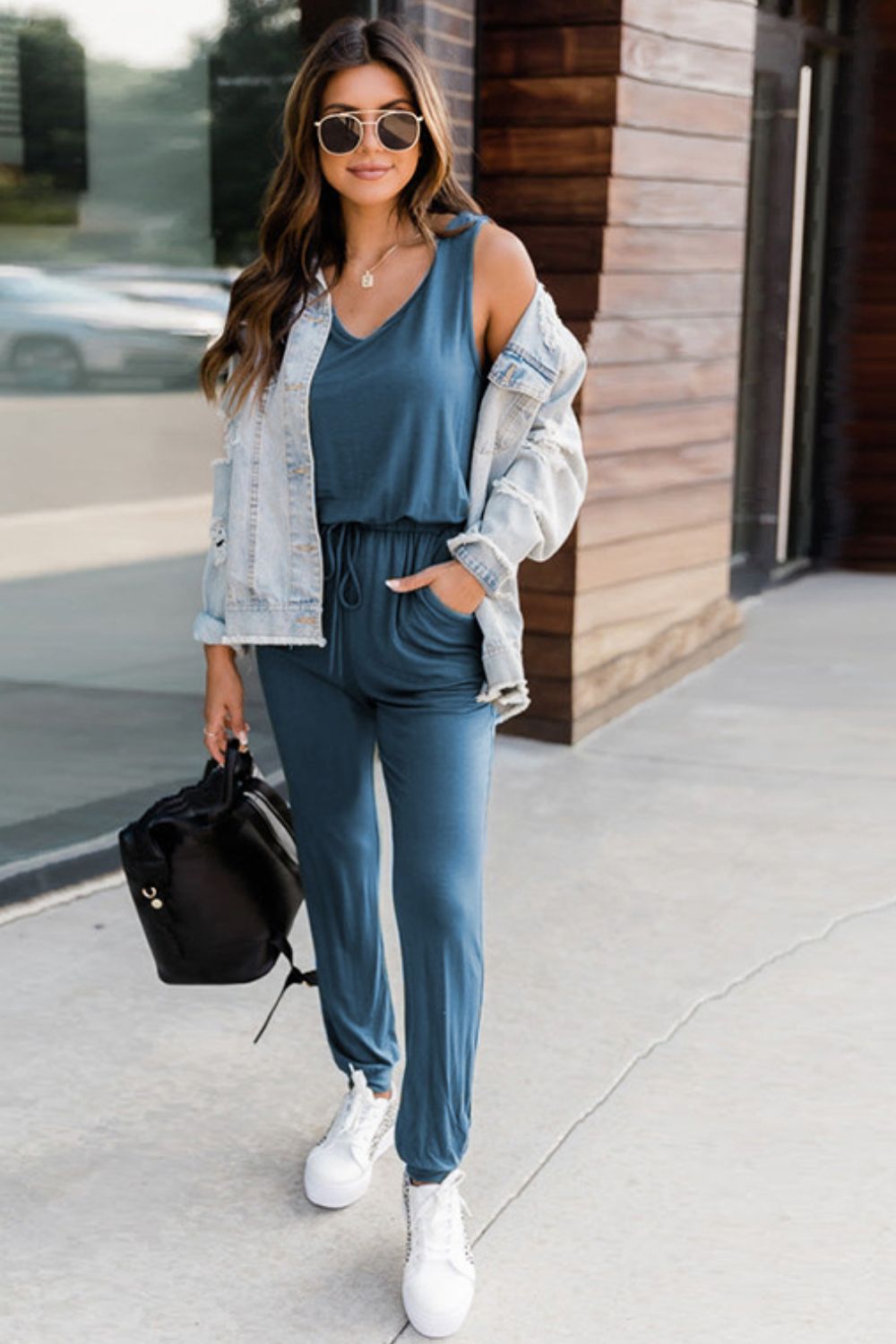 Peacock Blue relaxed drawstring waist jumpsuit with V-neck and pockets.