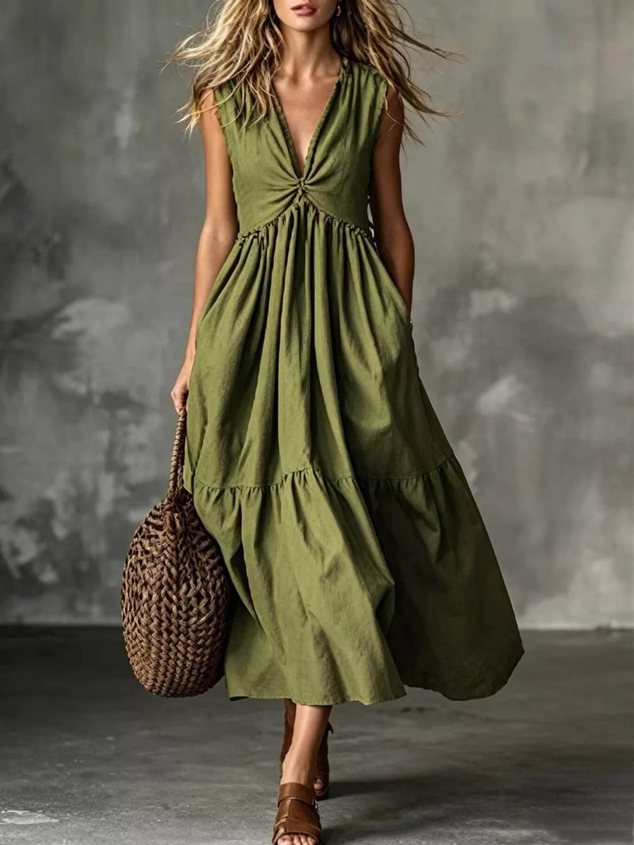 Olive green sleeveless midi dress with deep V-neck and tiered skirt.