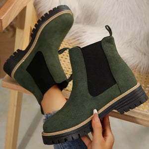 Green suede platform ankle boots with chunky sole and elastic side panels.