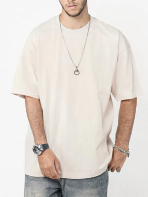 Beige oversized crew neck t-shirt with short sleeves and a relaxed fit.