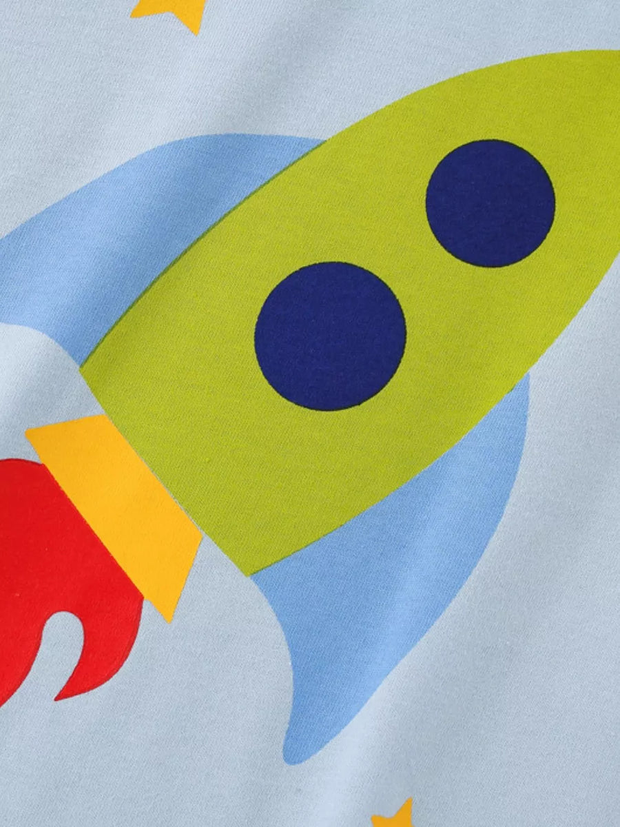 Light blue t-shirt with a green rocket graphic and blue circles, red flames, and yellow accents.