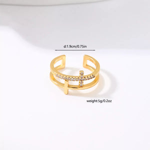Golden open ring with rhinestone cross detail and double band design.