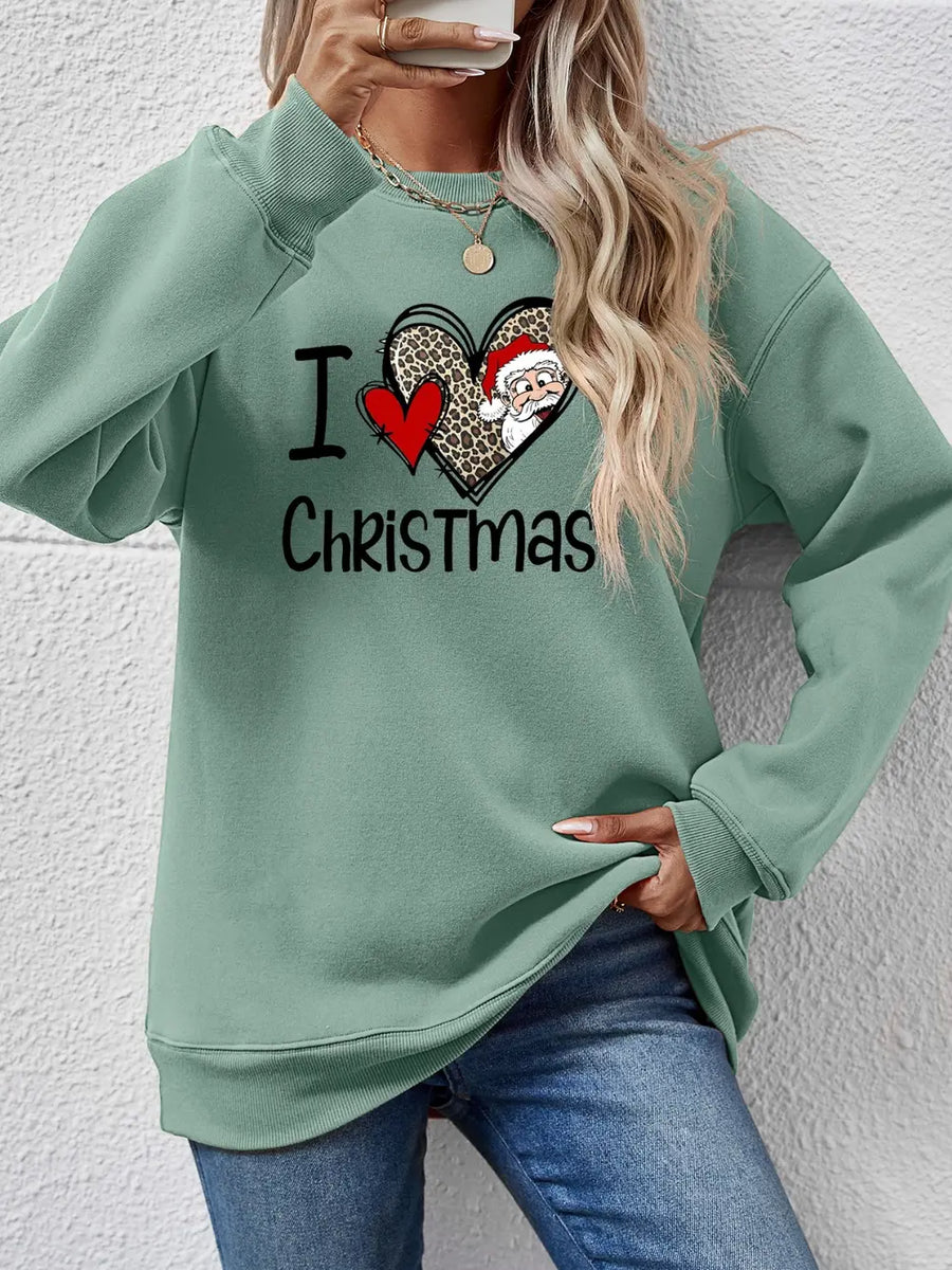 Sage green crewneck sweatshirt with festive heart graphic and Santa Claus detail.