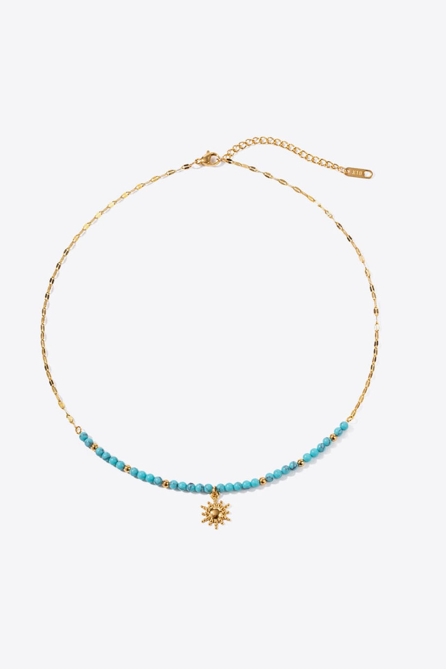 Gold celestial sunburst beaded necklace with turquoise beads and gold chain.