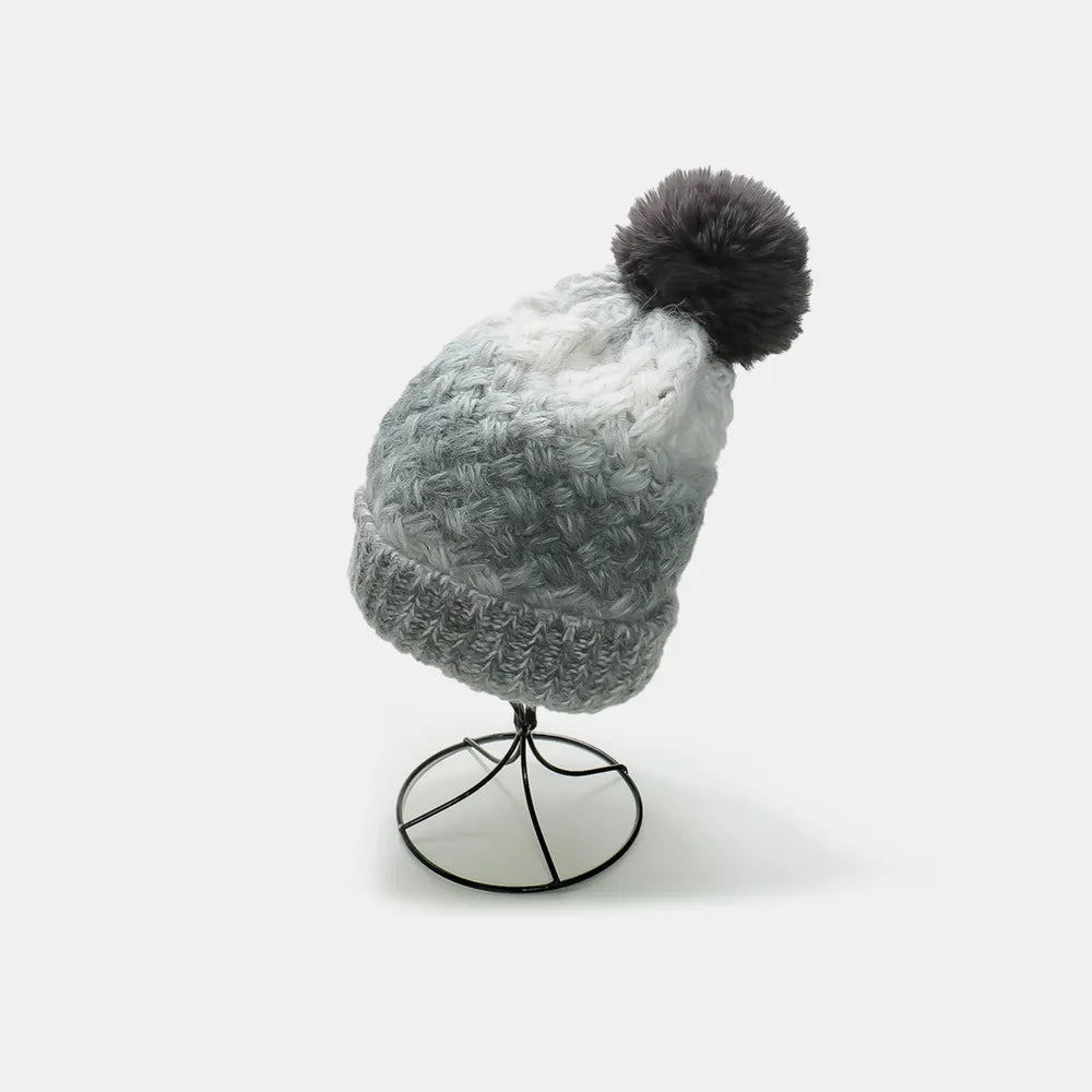 Gray ombre knit beanie with textured pattern and dark gray pom.