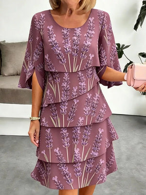 Plus-size lavender print tiered ruffle hem dress with cape sleeves.