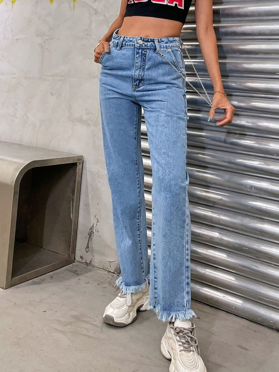 Light wash denim jeans with frayed hem and chain detail