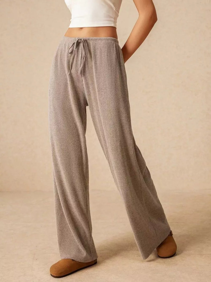 Gray ribbed wide-leg drawstring pants with a relaxed fit.