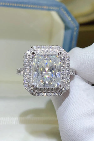 Radiant cut moissanite halo ring in silver with pave band.