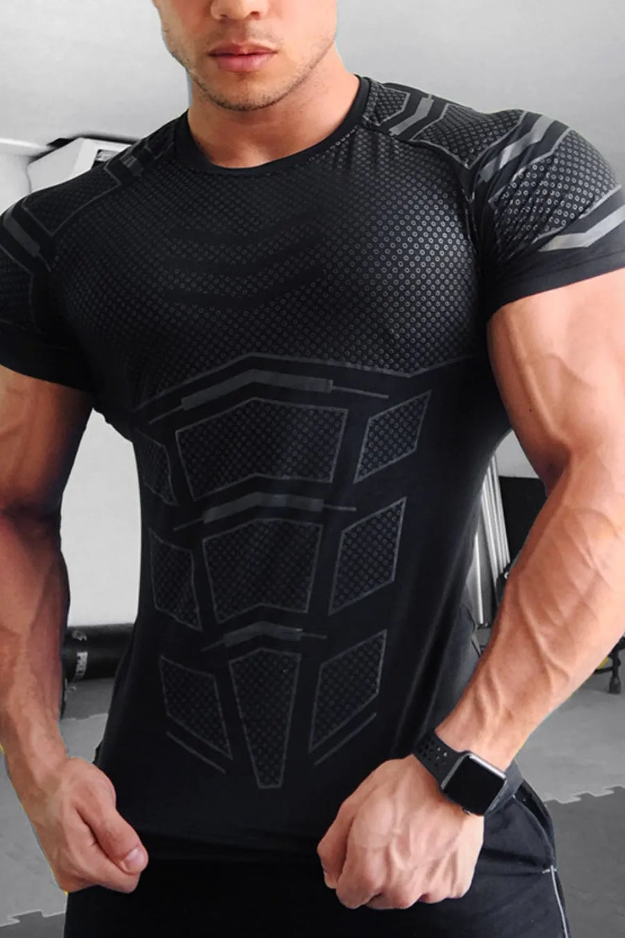 Black performance tee with geometric detail and textured pattern.