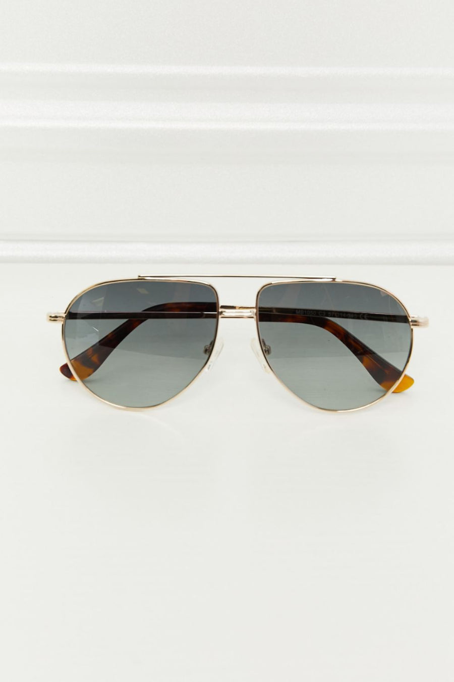 Gradient lens aviator sunglasses with gold frames and tortoise shell accents.