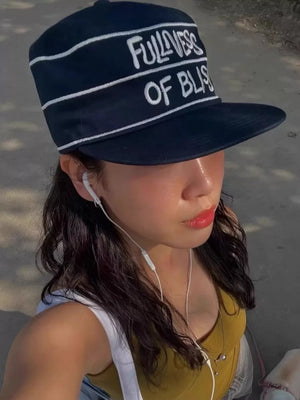 Navy blue cotton baseball cap with white embroidered slogan and stripes.