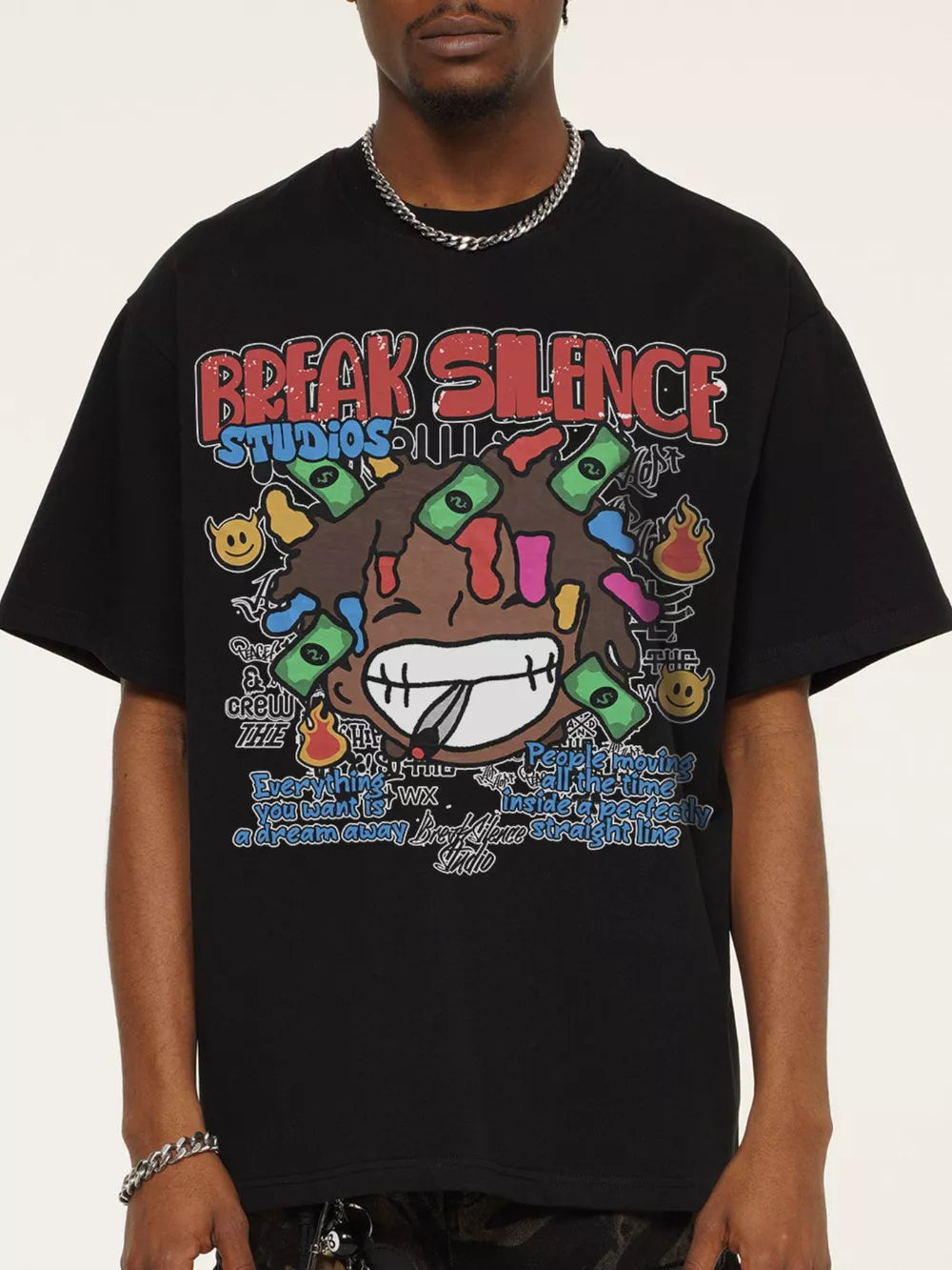 Black cotton blend graphic tee with bold "Break Silence Studios" print and cartoon character.
