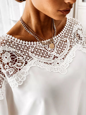 White lace-tie maternity shirt with intricate lace neckline detail.