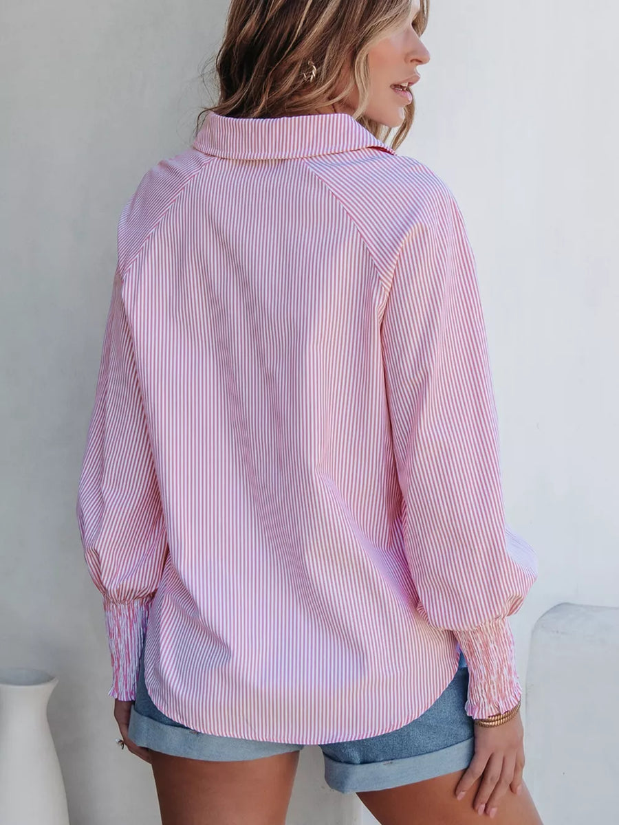 Pink and white striped collared shirt with balloon sleeves and smocked cuffs.