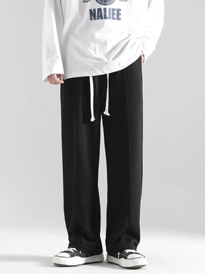 Black casual sweatpants with drawstring and loose fit.