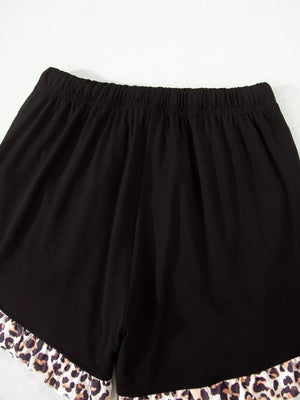 Black pajama shorts with elastic waist and leopard print ruffle trim