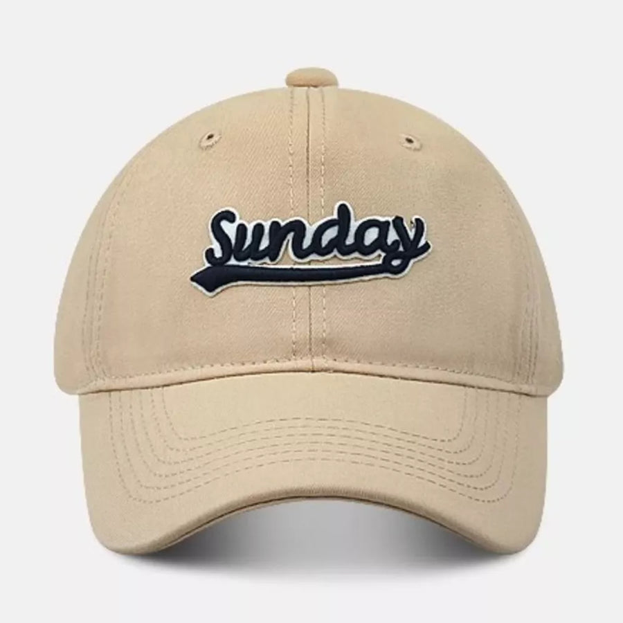 Baseball cap in tan cotton with embroidered navy Sunday text and underline detail.