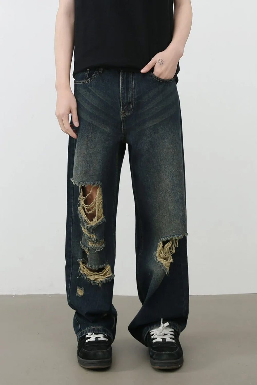Distressed wide-leg dark wash denim jeans with prominent knee tears and a relaxed fit.