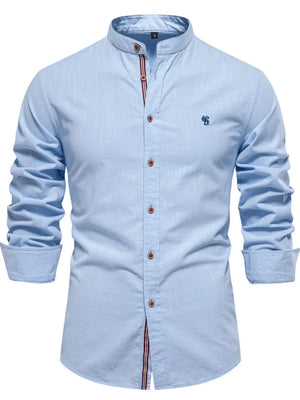 Light blue linen shirt with mandarin collar, button front, and embroidered detail.