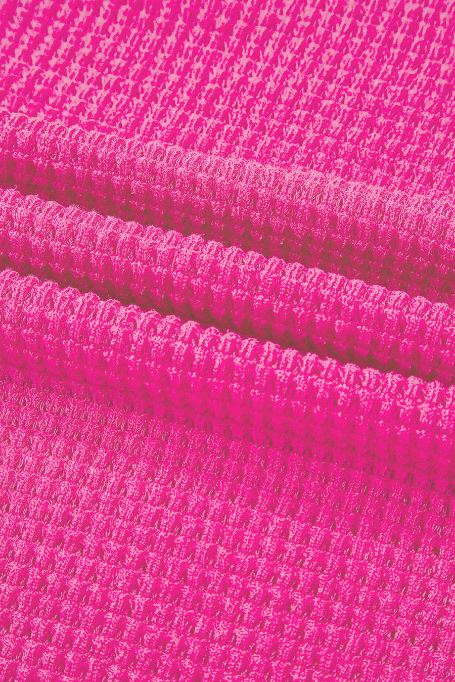Hot Pink waffle knit V-neck top with slit hem detail.
