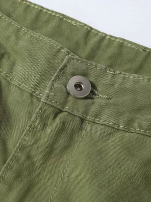 Green cargo pants with button closure and visible stitching detail