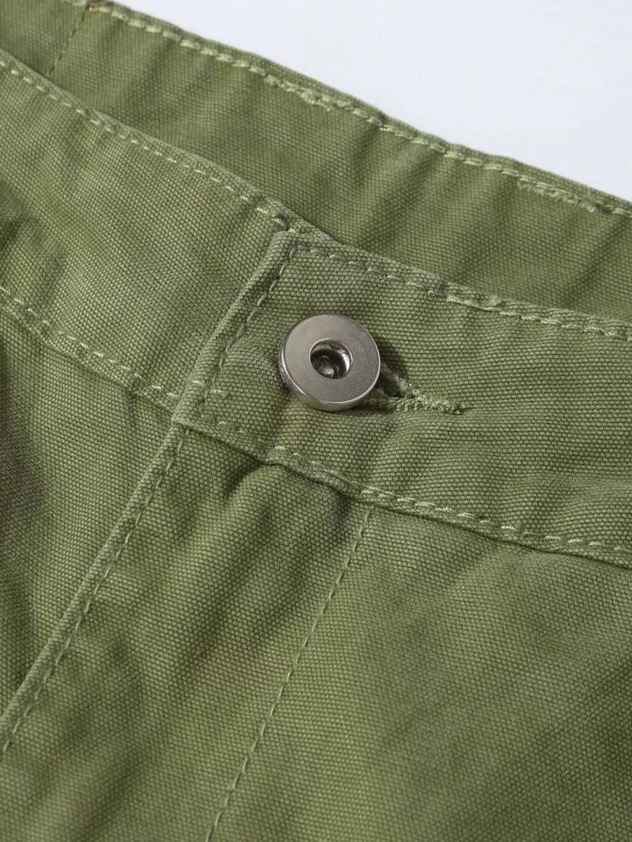 Green cargo pants with button closure and visible stitching detail