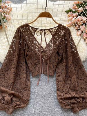 Brown sheer floral lace cropped shirt with balloon sleeves and back tie detail.