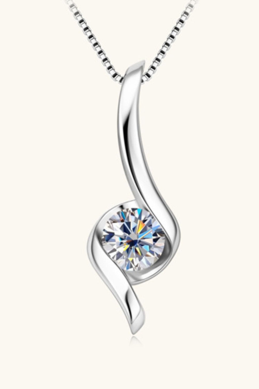 Silver moissanite pendant necklace with a sculpted swirl design.