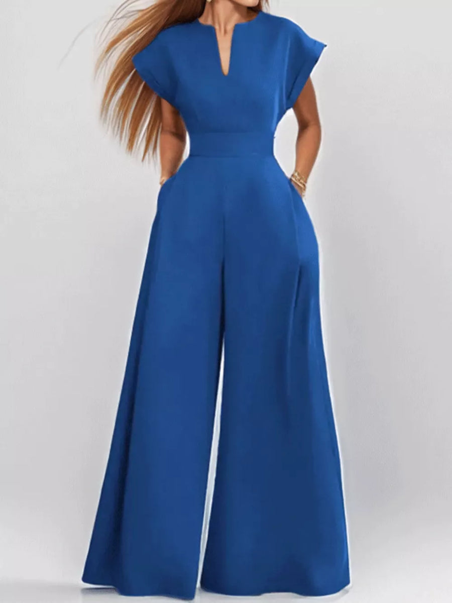 Navy wide-leg romper with notched neckline, short sleeves, and pockets.