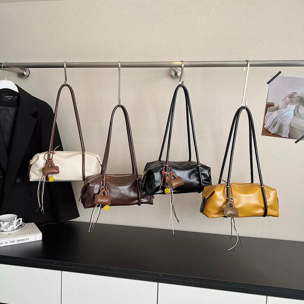 Chic pu leather shoulder bags in yellow, black, ivory, and brown with charm details.