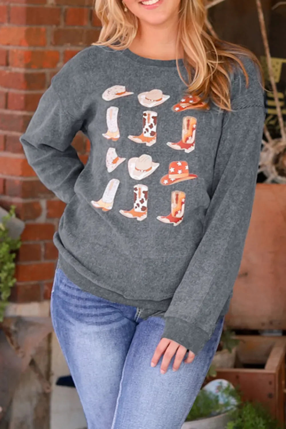 Dark gray corded sweatshirt with a western boot and hat print