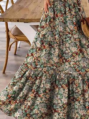 Floral tiered maxi dress with spaghetti straps in Black Forest, polyester, with a ruffled hem.