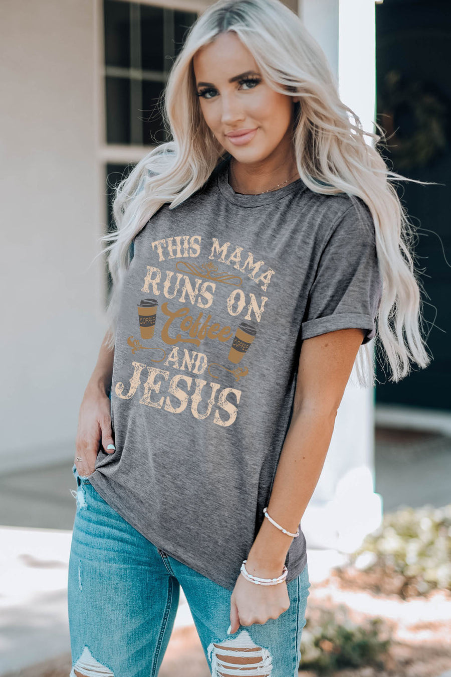 Graphic tee in mid gray with "This Mama Runs on Coffee and Jesus" text and coffee cup graphics.