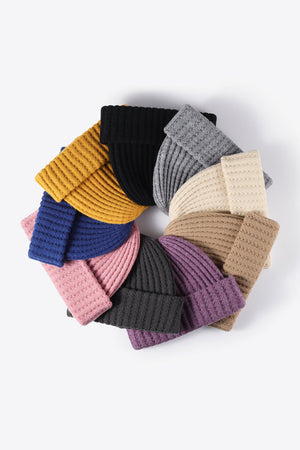 Textured ribbed knit beanies in multiple colors arranged in a circle