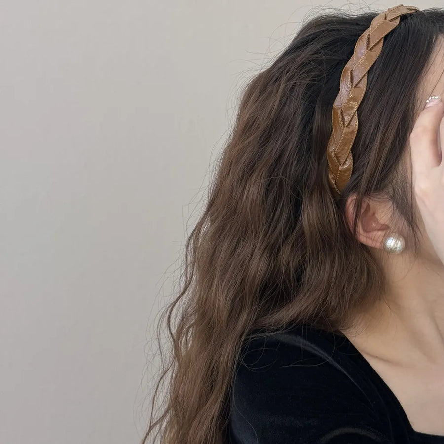 Woven faux leather headband in camel with braided detail.