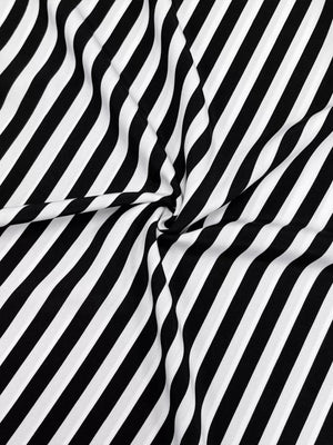Notched midi dress in black and white stripe fabric with long sleeves.