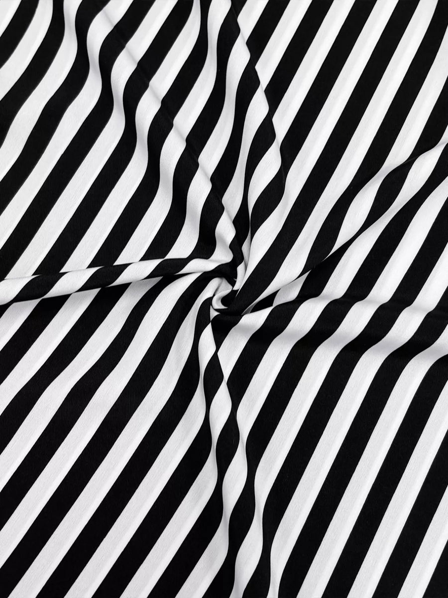 Notched midi dress in black and white stripe fabric with long sleeves.