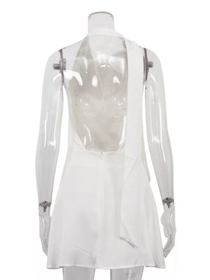 White halter neck mini dress with a low back and tie detail.
